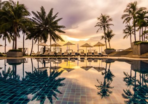 Beautiful luxury outdoor swimming pool with umbrella and chair in hotel and resort for travel and vacation